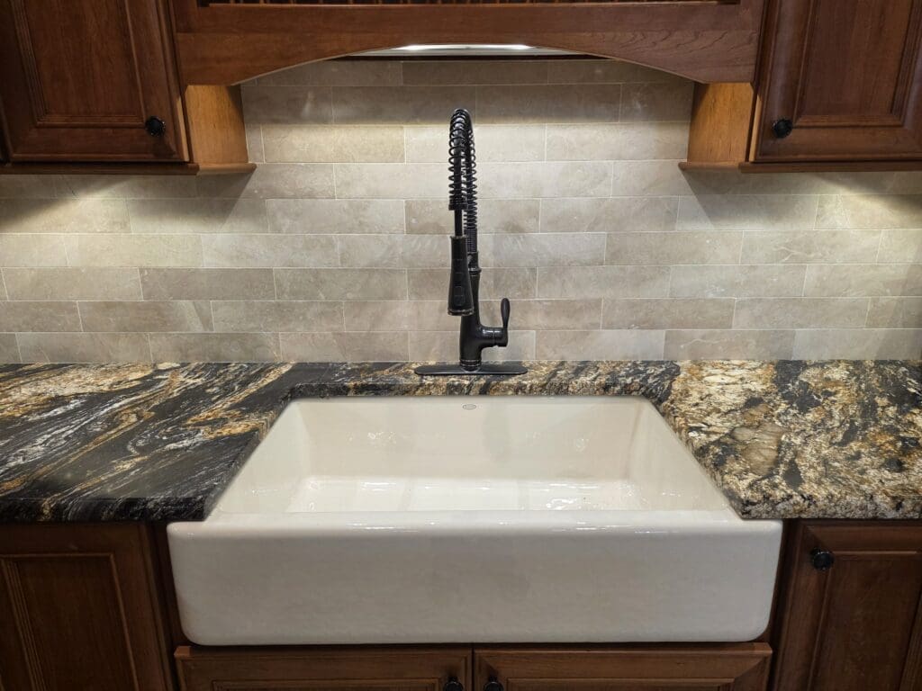 A picture of a kitchen renovation done in Alexandria, Virginia. Shows a granite countertop with a farmhouse sink.