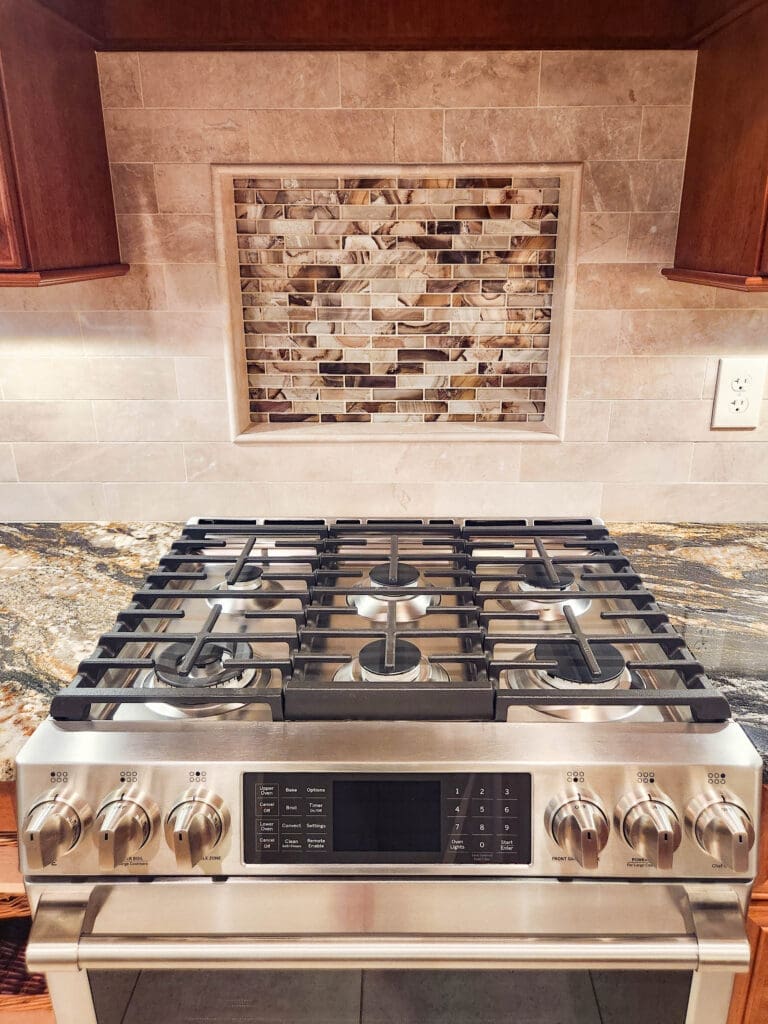 An image of a kitchen remodel done in Alexandria, Virginia. It shows an accented backsplash and stainless steel smart oven.