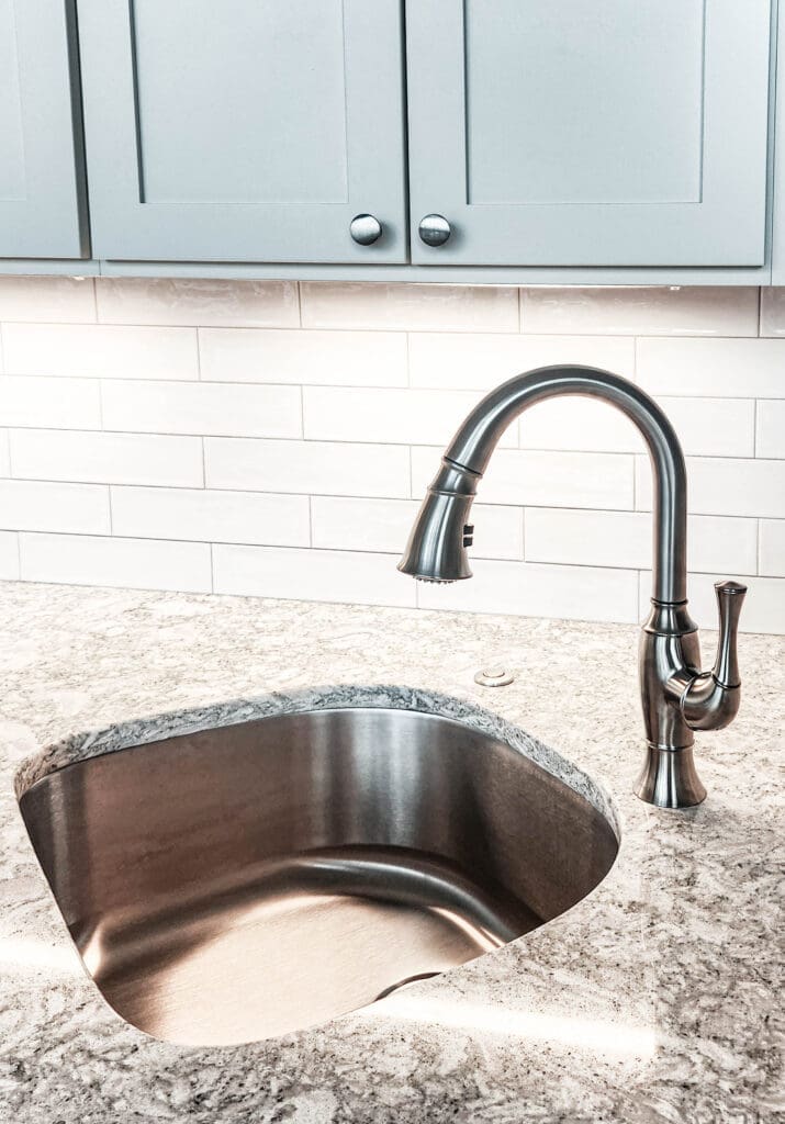 A picture of a kitchen renovation done in Alexandria, Virginia. The picture showcases the white subway tile backsplash and underlighting cabinets.